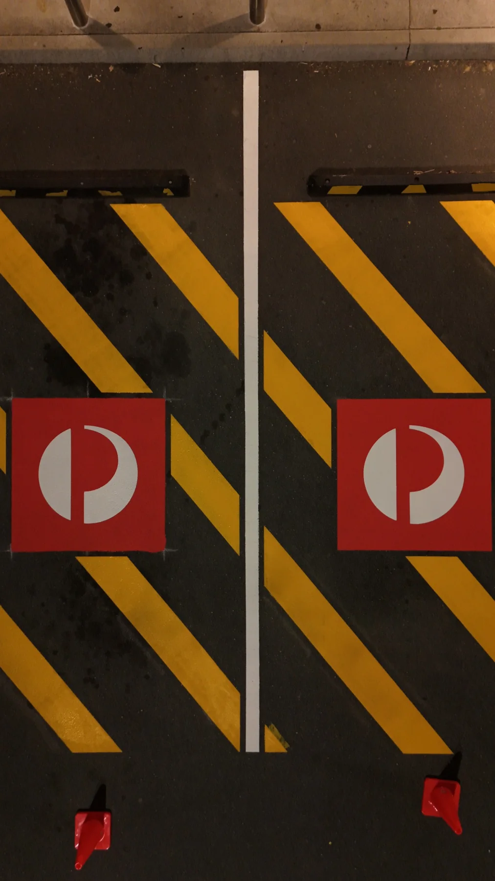 Close-up aerial view of the Australia Post pavement symbols and painted bay separators