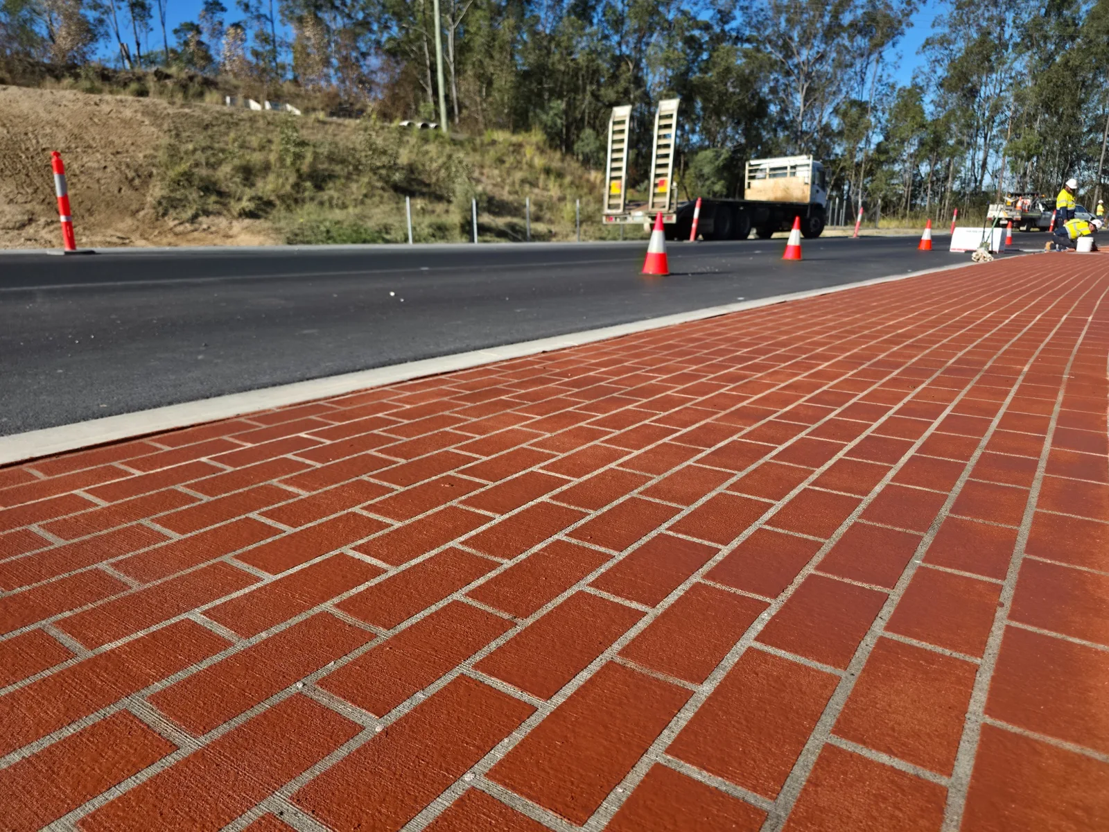 Brick-pattern decorative overlay beside a roadway