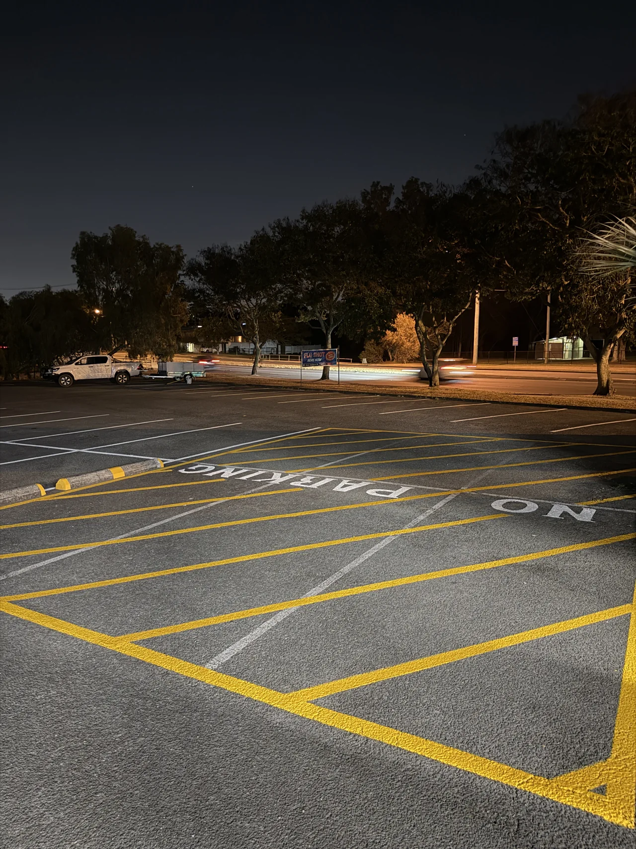 Repainted wheel stops beside the refreshed yellow chevrons at the Sunnybank car park
