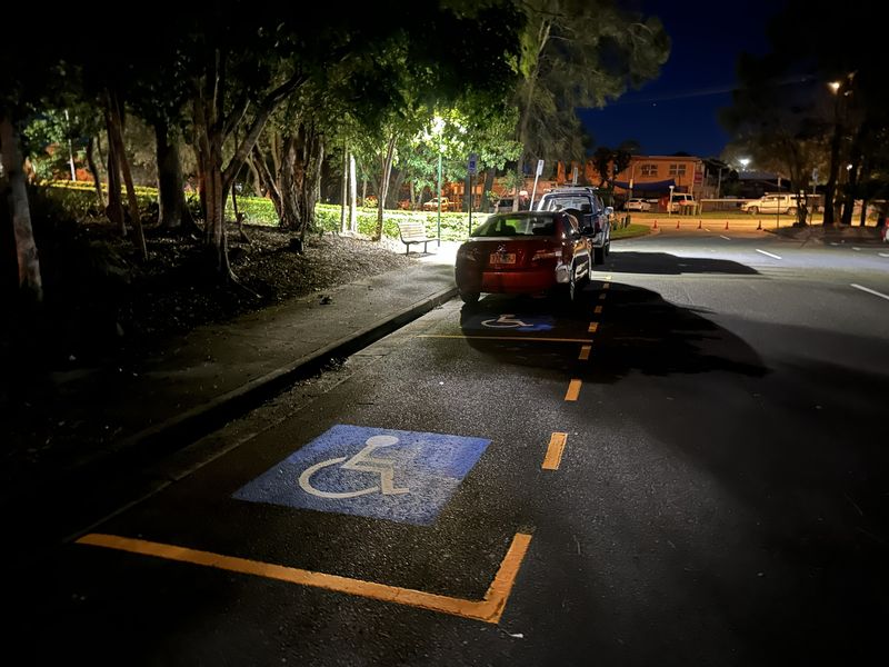 Accessible parking bay symbol and yellow bay outline on a kerbside parking bay in Redland Bay