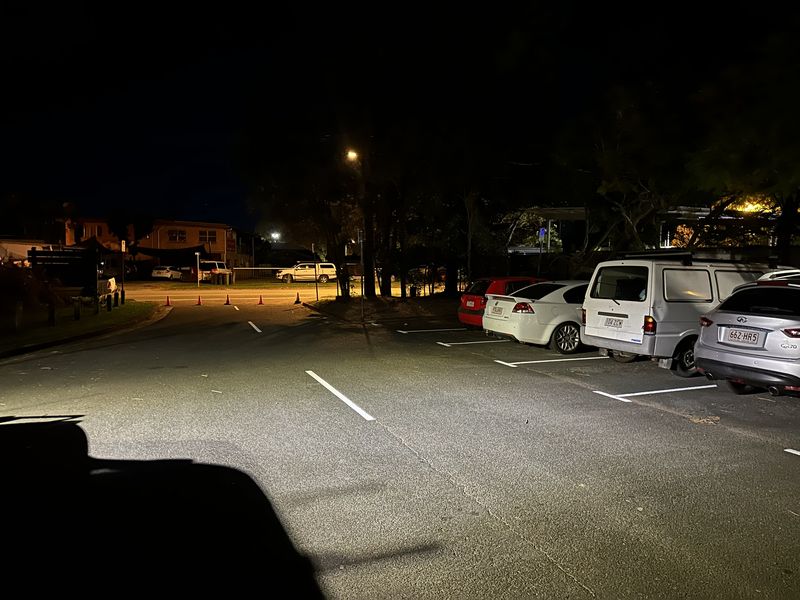 Freshly marked white parking bays in a sealed car park at night in Redland Bay