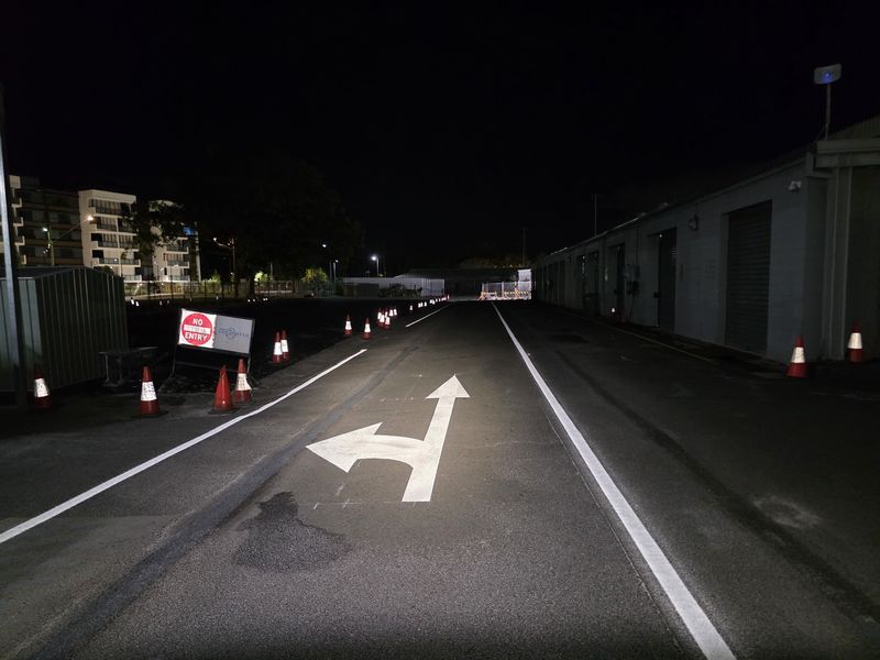 Turn arrow and lane lines marked on an internal roadway with cones in place on the Gold Coast