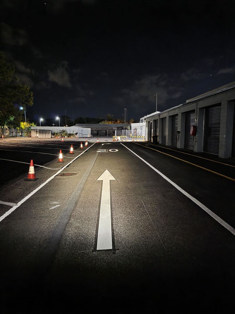 Speed limit 20 numerals and a straight ahead arrow marked on a site roadway on the Gold Coast